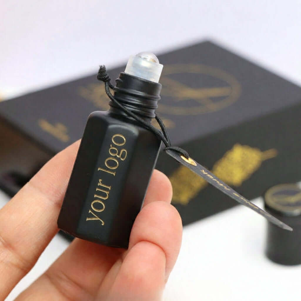 Perfume Oil Bottle with Box displayed in hand, featuring luxury design and refillable option for premium presentation.